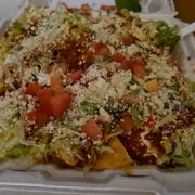 a large salad in a styrofoam container