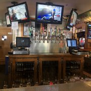 a bar with multiple televisions on the wall