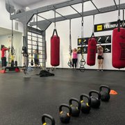 NXT Level Room full of Brand names equipment, weights, and TRX