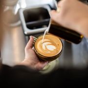 Kennedy making latte art in a personal mug!