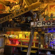 a cross street sign in a bar