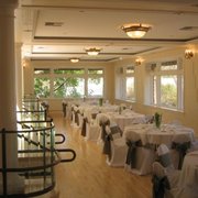tables with white tablecloths and black bows