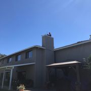 Leo vacuuming down our fireplace chimney