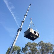 Removing the old unit from a roof.
