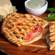 a wooden cutting board with a sandwich cut in half