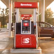 a red gas pump at a gas station