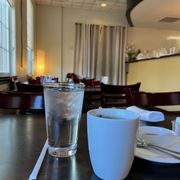 a glass of water and a cup of coffee