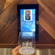a person holding a glass of beer