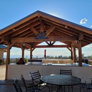 a patio with a grill and table