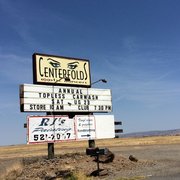 a sign for a store in the middle of nowhere
