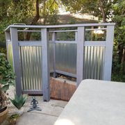 A finished view of the shower exterior and a bit of the interior! The stainless steel hardware adds durability and style.