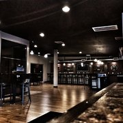 a view of a bar with a counter and stools