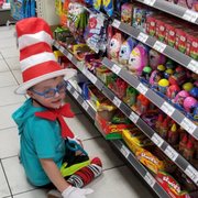 a toddler in a cat in the hat costume
