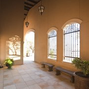 a courtyard with a bench and a potted plant