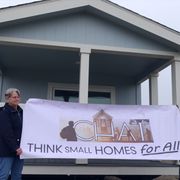Board members Leslie Johnson and Robert Trausch in front of the community center building for Everhart Village.