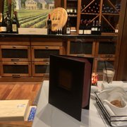 a table with wine and a menu