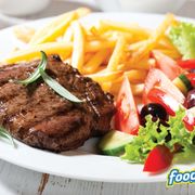 a plate of food with french fries and salad