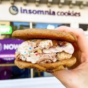 a hand holding a cookie sandwich