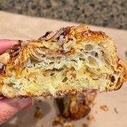 a hand holding a half eaten pastry