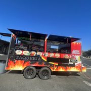a taqueria truck parked in a parking lot