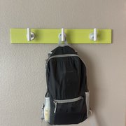 Hooks between the wet bar and the sofa area.