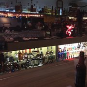 a bar with a lot of bottles of alcohol
