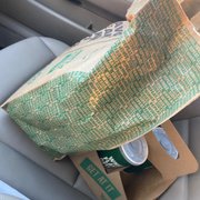 a bag of food in the passenger seat of a car