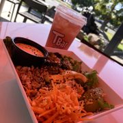 a bowl of food and a drink