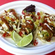 Ahi poke tacos with mango Thai basil salsa, wasabi crema slaw, house made hot sauce and kaffir lime