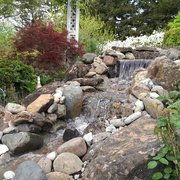 a waterfall in a rock garden