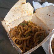 a bowl of noodles and a burrito
