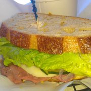 a ham sandwich with lettuce and cheese