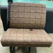 Heavily modified Ford Transit bench seat. Custom shape foam , narrowed frame and custom cover in distressed vinyl.