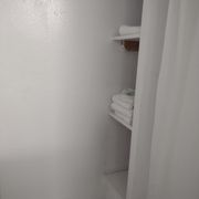 Shelves area next to shower with towels