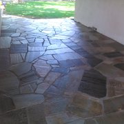 Quartzite flagstone on concrete base.