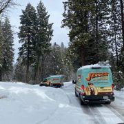 Jessee Heating and Air vans driving through the snow