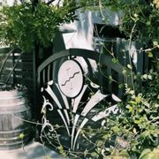 a metal gate with a clock on it
