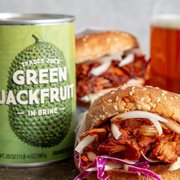 a pulled pork sandwich next to a can of green jackfruit