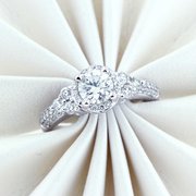 14 kt white gold engagement ring, halo design, with center diamond .73 carat, i-j/i-1, and 48 that equals .80 carat total weight, g-h/i1.