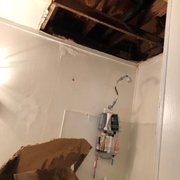 a bathroom with a hole in the ceiling