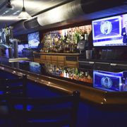 a bar with several televisions on the wall