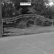Arched gate w/sunburst design and name in middle