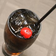 a drink with a cherry on the top