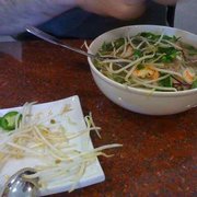 Super Bowl with dish of fresh veggies nearly emptied into the Pho