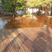 a wooden deck in a backyard