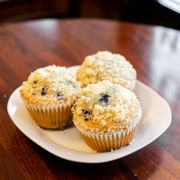 three blueberry muffins on a plate