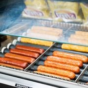 hot dogs and buns on a grill