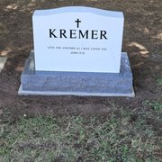 White Italian marble with a granite base. The family wanted the back engraved and it looks great