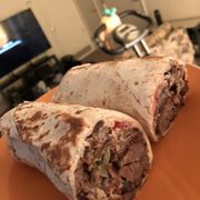 two burritos on an orange plate