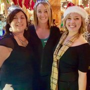 three women standing in front of a bar